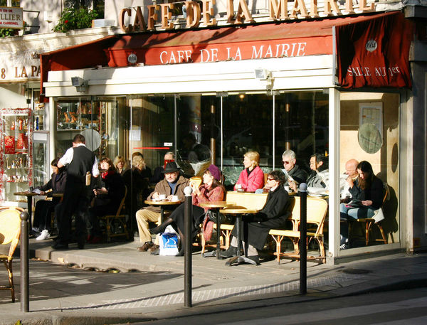 Sitting outside the Café de la Mairie in winter, Paris, France