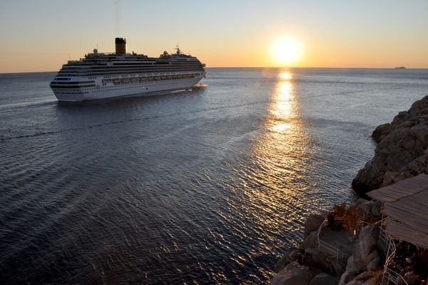 Cruise ship leaving Dubrovnik, Croatia at sunset