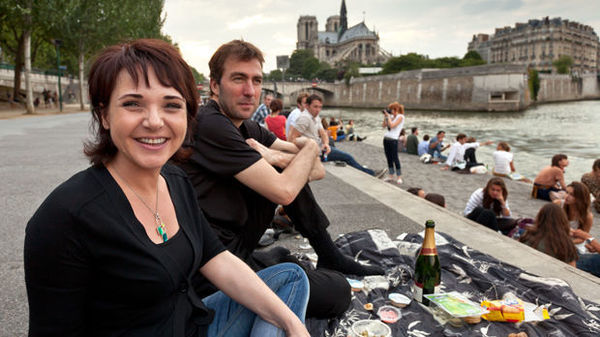 Riverbank picnic near Notre-Dame Cathedral, Paris, France