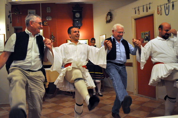 Traditional dancers with restaurant guests, Nafplio, Greece