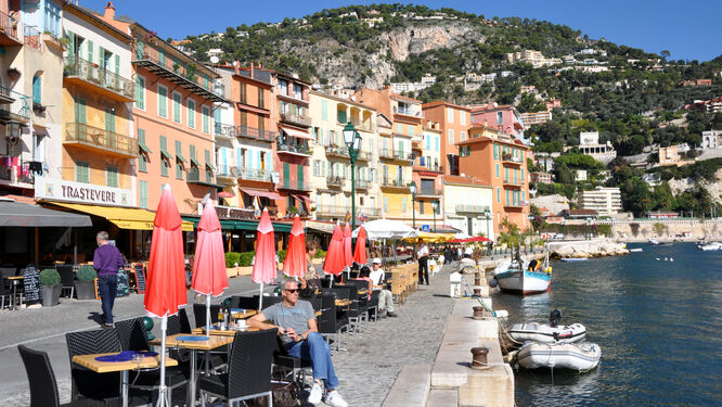 Sidewalk cafés lining the harborside of Villefranche-sur-Mer, France