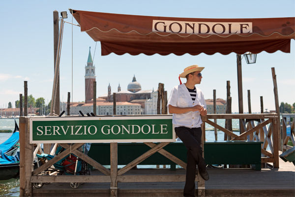 Gondola stand and gondolier, Venice, Italy
