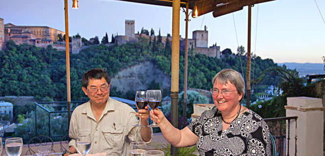 Tour members toast with a view of the Alhambra in Granada, Spain