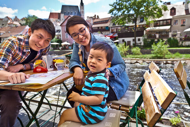 A family enjoying a riverside break in Český Krumlov, Czech Republic
