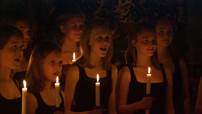 A candle-lit group of choirgirls