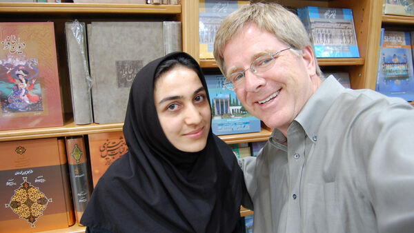 Rick and a woman in a bookstore, Iran