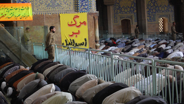 Crowds bowing in prayer, Iran