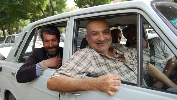 Cheerful passengers in a car, Iran