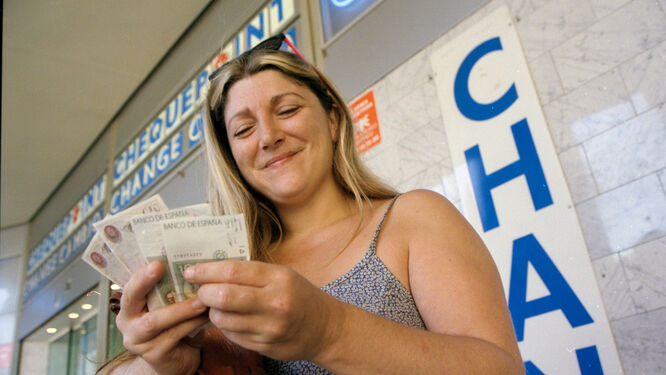 Lady making change in pesetas, Spain