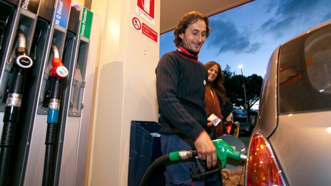 Man using pump at gas station