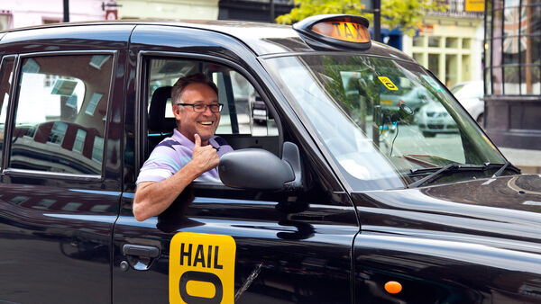 London taxi driver giving thumbs-up sign