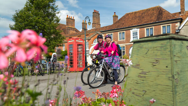 Bicyclists near phone booth in Salisbury, England