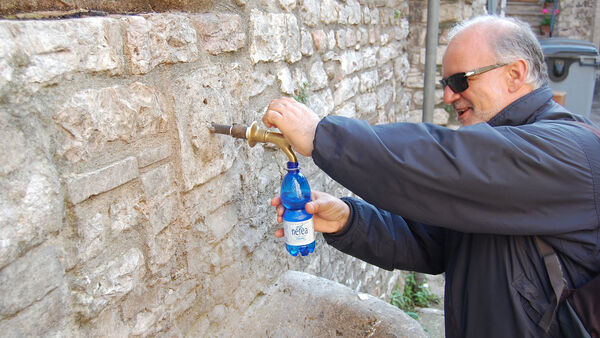 Man filling up a water bottle