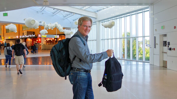 Rick Steves at the airport with his carry-on luggage