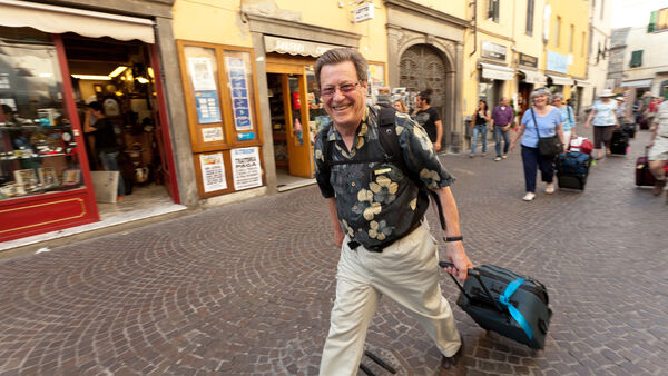 Man with rolling luggage bag