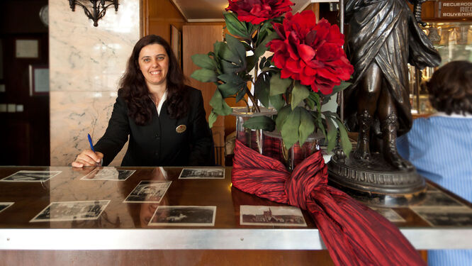 Woman at reception desk in Coimbra, Portugal