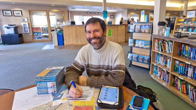 Customer doing research at Rick Steves' Europe in Edmonds, Washington