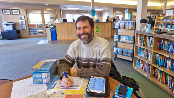 Customer doing research at Rick Steves' Europe in Edmonds, Washington