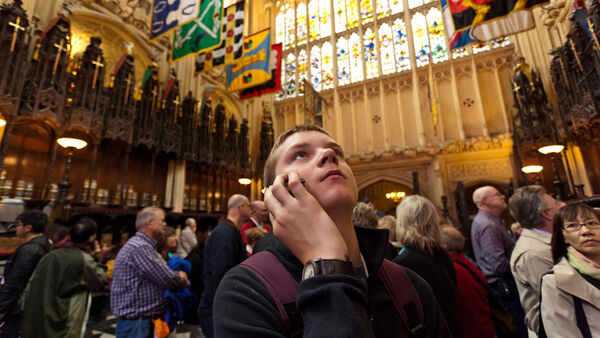 Boy listening to an audio tour in Westminster Abbey, London, England