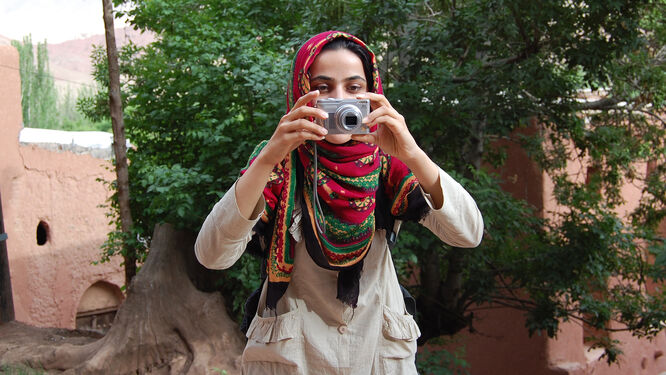 Woman using camera, Iran