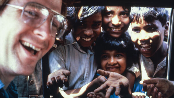 Rick Steves in a car with children looking through the window