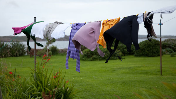 Washed clothes hanging out to dry on a washing line. Male