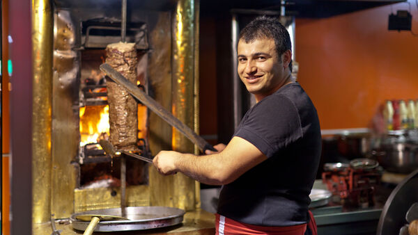 Gyro vendor carving meat