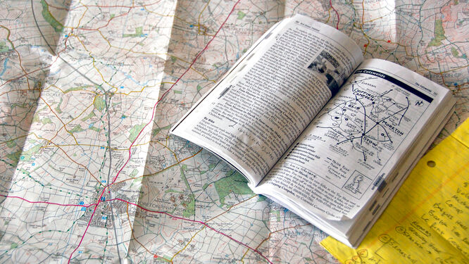 Guidebook open on top of map