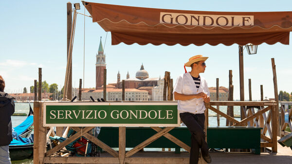 Gondola stand and gondolier, Venice, Italy