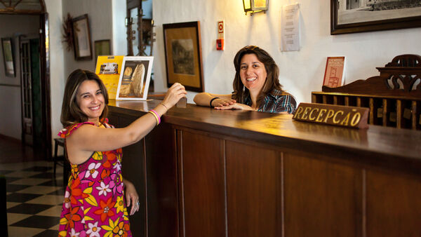 Guest at hotel reception desk in Portugal