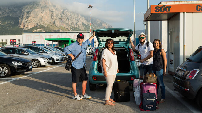 People in rental car station parking lot, France