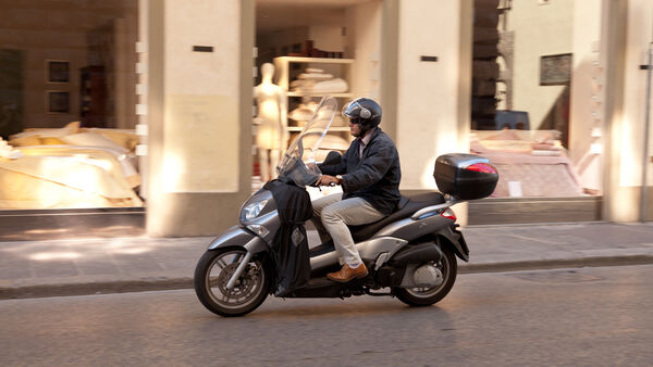 Vespa driver, Florence, Italy