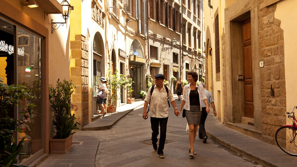 Couple walking on side street, Florence