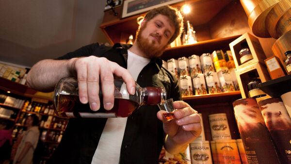 Bartender pouring whisky shot, Inverness, Scotland