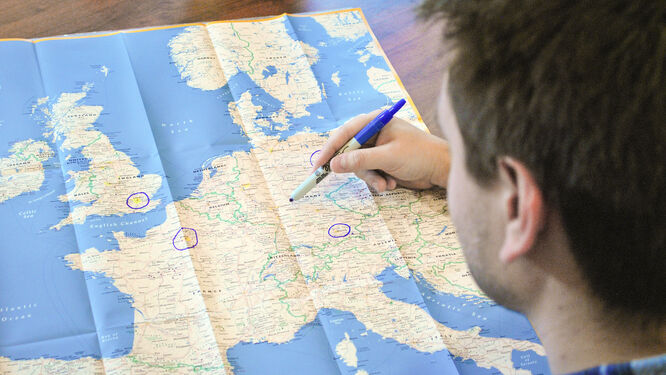 Person marking a map with a pen