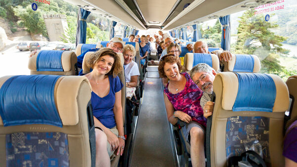 Happy travelers on tour bus