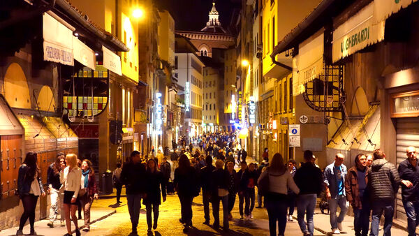 People strolling the narrow pedestrian streets of Florence during its nightly "passeggiata"