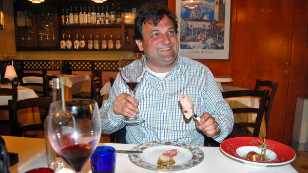An Italian man enjoying mortadella in a small restaurant in Verona