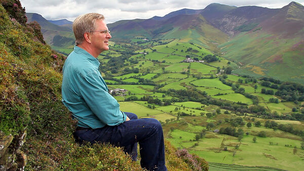 Rick Steves taking in the view of England's Lake District from a ridge called "Catbells"