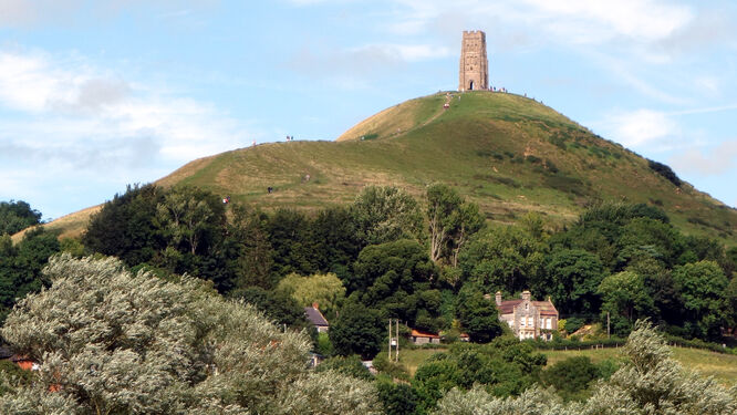 The terraced hill called Glastonbury Tor, topped by the medieval St. Michael's Tower, in Glastonbury, England