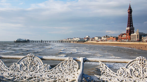 The long, sandy beach and distinctive ironwork tower of northern England's Blackpool
