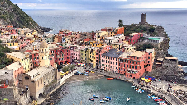 The colorful seaside Italian town of Vernazza as seen from the hiking trail that connects it to other Cinque Terre towns