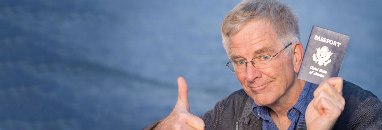 Rick Steves holding a passport