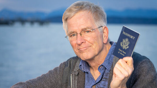 Rick Steves holding a passport