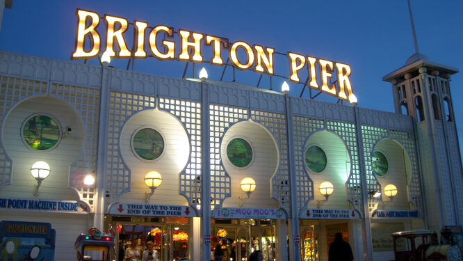 Brightly lit sign spelling out "Brighton Pier" 