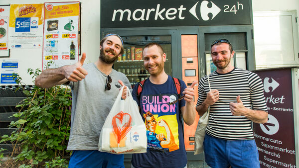 Three guys at a grocery market in Italy