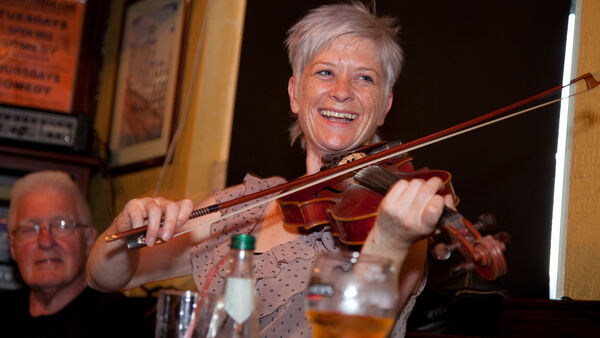 Woman playing the fiddle in a Dublin pub