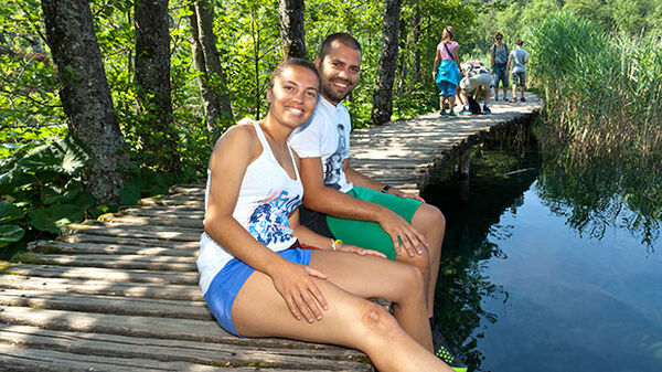 croatia-plitvice-young-couple-sitting-by-water