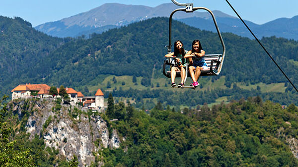 girls-on-chairlift-above-lake-bled-slovenia