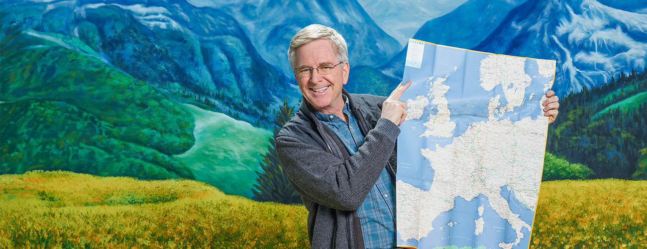 Rick Steves with map in the Alps